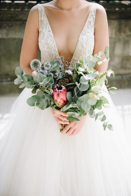 Bride holding beautiful floral bouquet on the day of her wedding