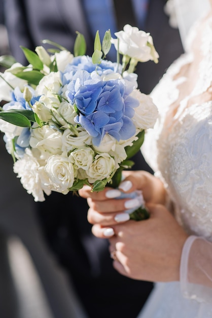 A bride holding beautiful wedding bouquet. Close up