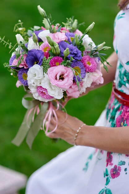 Bride holding beautiful wedding bouquet close up