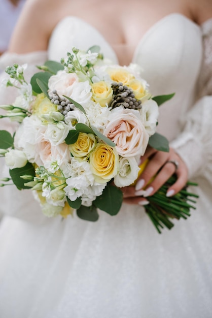 Bride holding beautiful white wedding bouquet Closeup