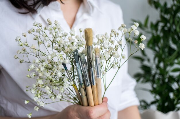 Bride holding bouquet with paintbrush Artist consept