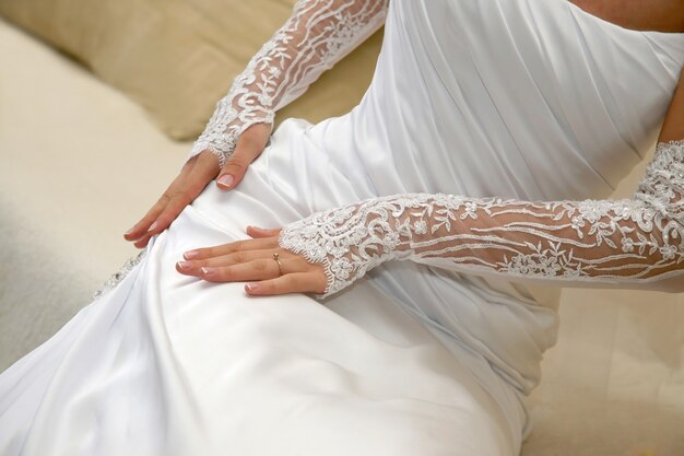 Bride holding hands on the dress