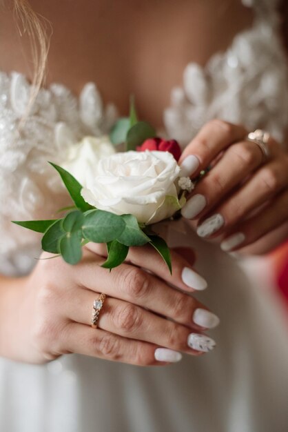 Bride holding tender buttonhole Closeup