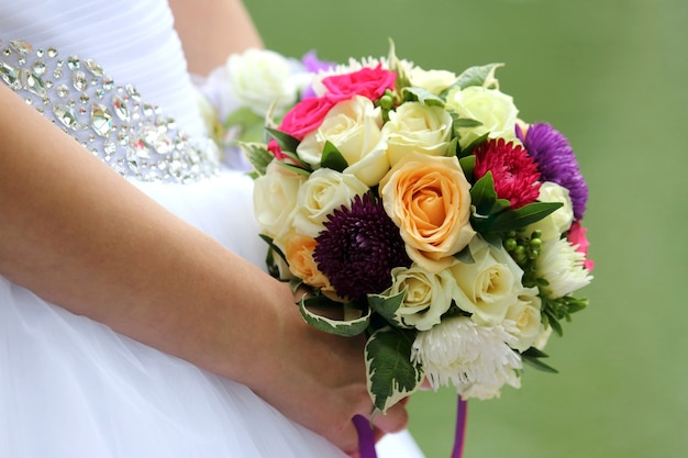 Bride holding wedding bouquet closeup