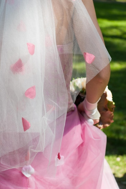 Bride holding wedding bouquet at sunny day