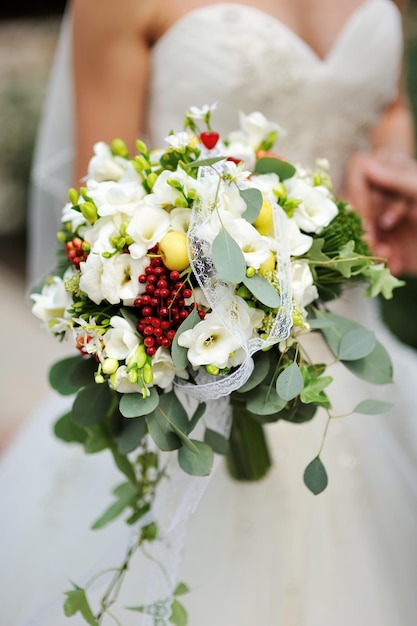 Bride holding wedding bouquet with white flowers