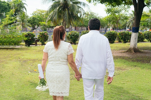 The bride holds a beautiful bouquet of white flowers Wedding day ceremony outdoors