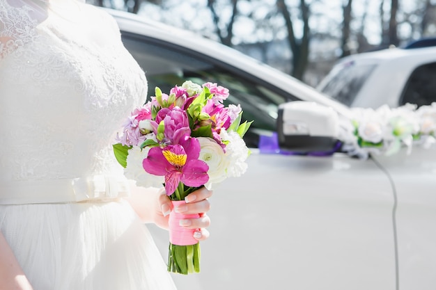 The bride holds the beautiful wedding bouquet