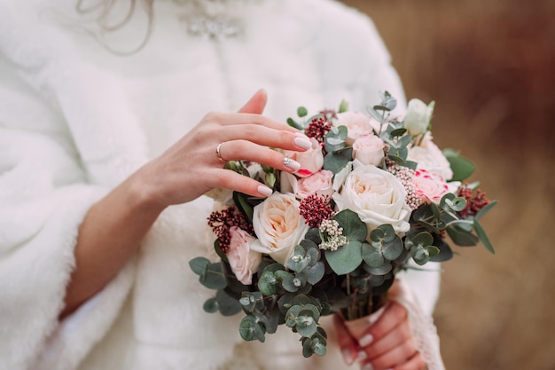 The bride holds a delicate bouquet of flowers in her hands 4340