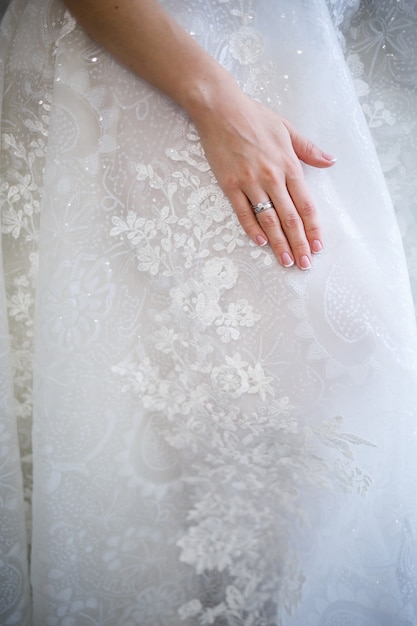 The bride holds in her hands a beautiful wedding dress