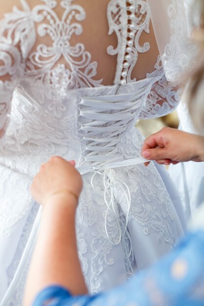 The bride holds in her hands a beautiful wedding dress