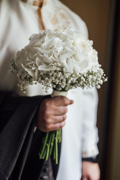 Bride holds a wedding bouquet wedding dress wedding details