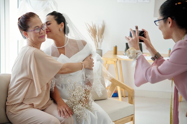 Bride Kissing Mother of Cheek