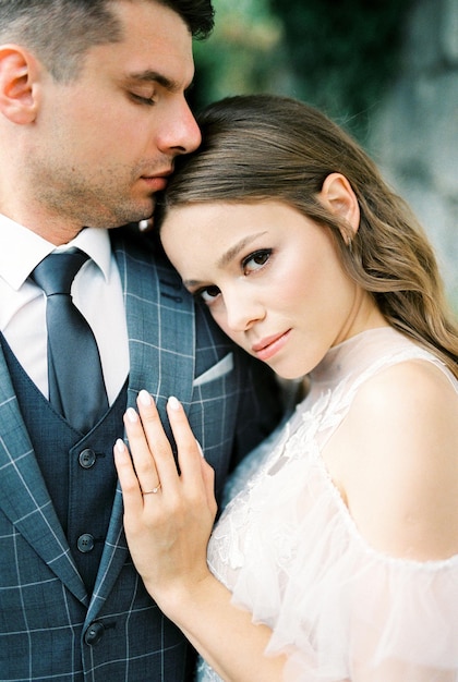 Bride laid her head on the groom shoulder touching his chest