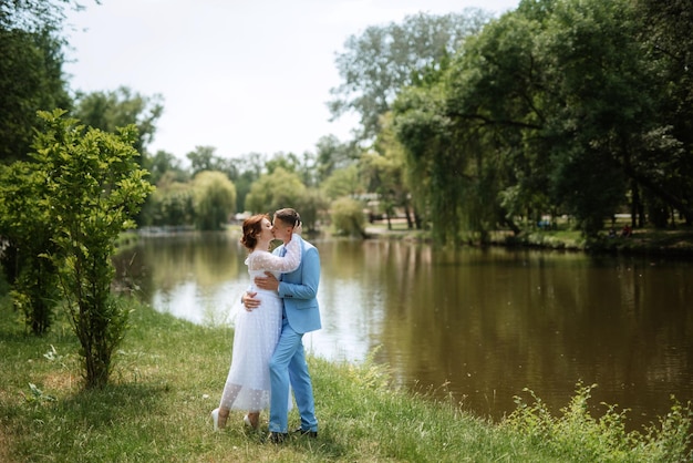 Bride in a light wedding dress to the groom in a blue suit