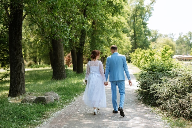 Bride in a light wedding dress to the groom in a blue suit