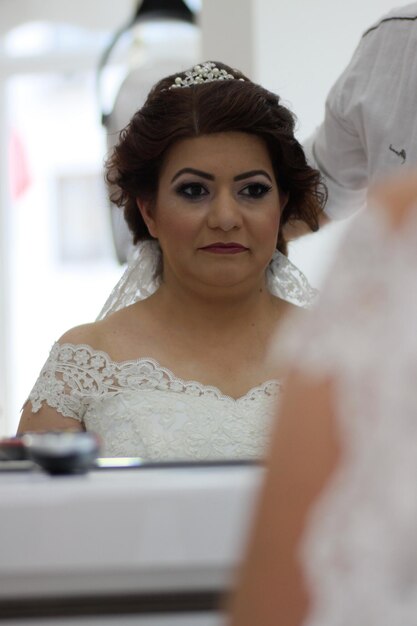 Photo bride looking in mirror