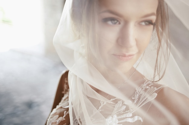 Photo bride looks brave while veil hides her face