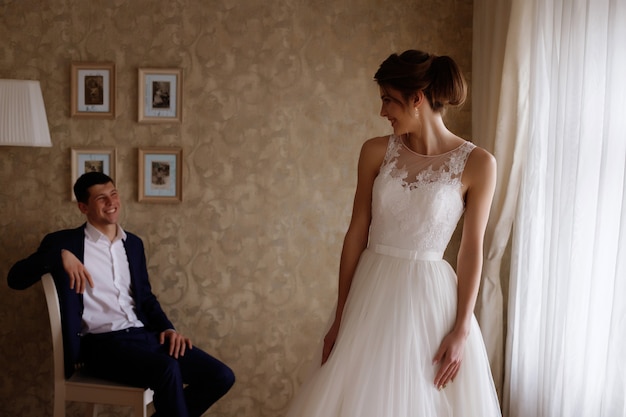 bride looks at the groom and smiles