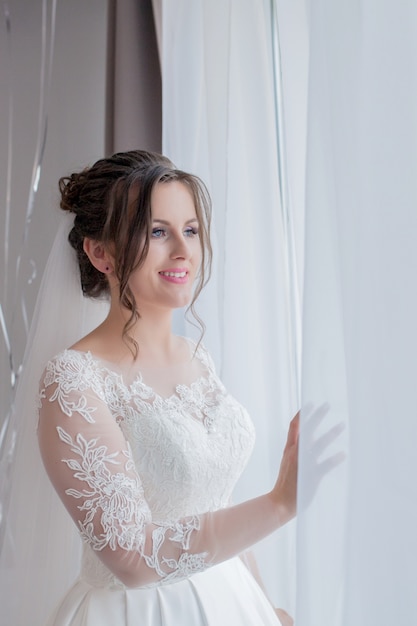 Bride looks out of the window,wedding day, Morning of the bride