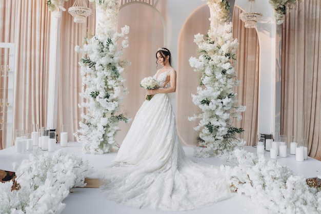 bride near wedding arch