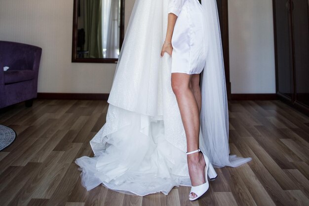 A bride in a peignoir with a wedding dress