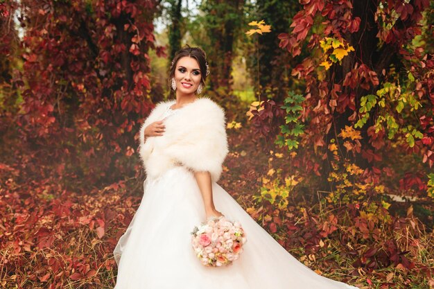 The bride portrait in the autumn forest Bride in wedding dress on natural background Wedding day