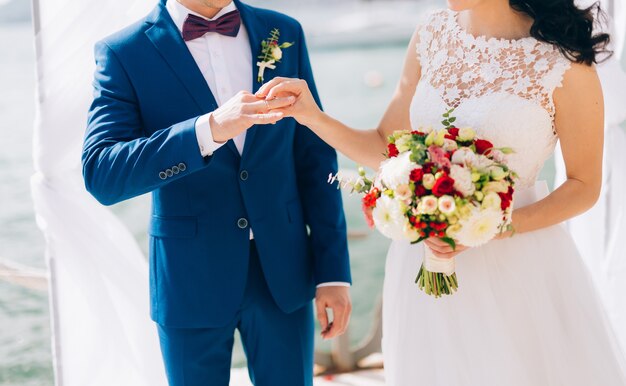 The bride puts the ring on the bridegroom at the wedding ceremony