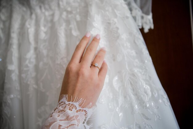 Bride puts on a wedding dress