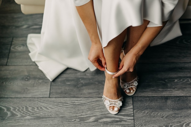 Bride putting on her shoes, close up