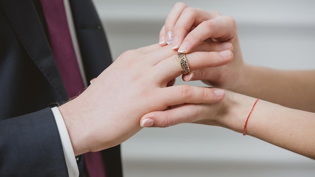 Bride putting a wedding ring