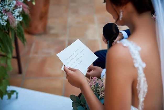 Bride reading wedding vows.