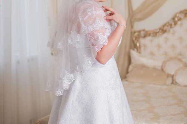 Bride in a room in a wedding dress