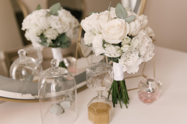 The bride's bouquet and the beautiful details of the bride's morning