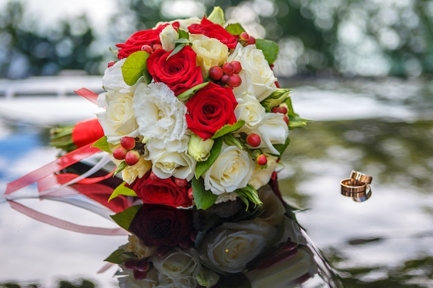 Bride's bouquet and wedding rings.