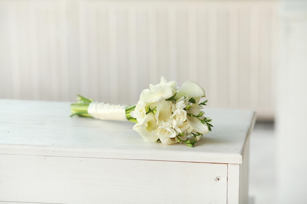 Bride's Bouquet of white calla flowers on white wood Wedding