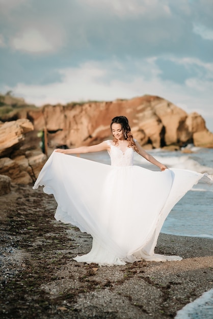 Bride on the shore of the black sea in the sunset light