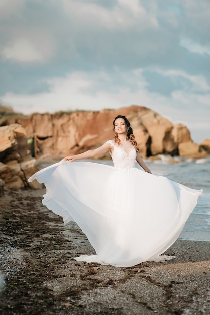 Bride on the shore of the black sea in the sunset light