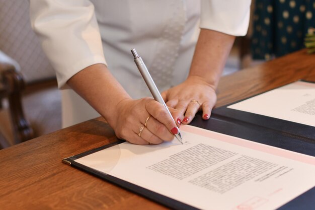 The bride signs the marriage registration documents