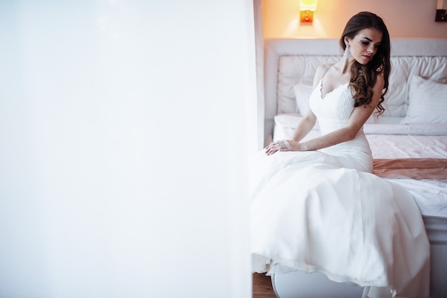 Bride sitting on the bed