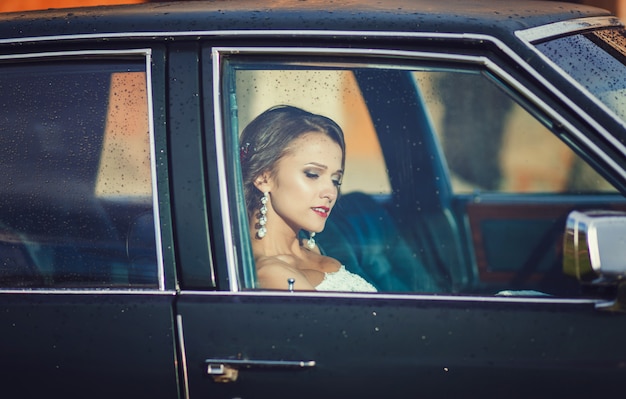 Bride sitting in car's passenger's seat