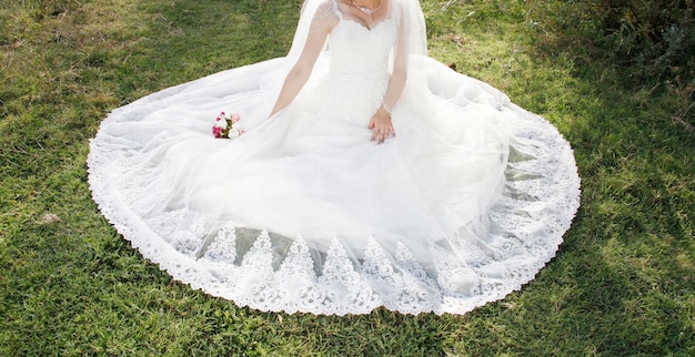 Bride sitting on the grass