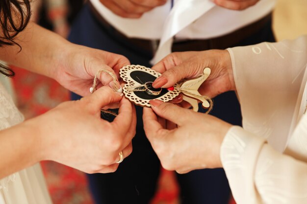 Bride takes wedding rings from a wooden heart 