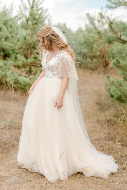 Bride walking in the pine forest