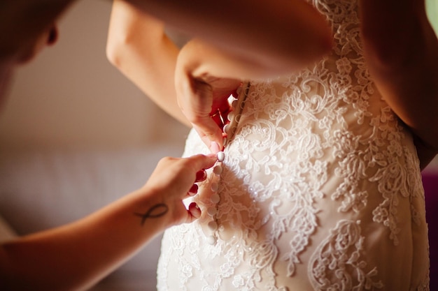 Bride wearing wedding dress close up hands