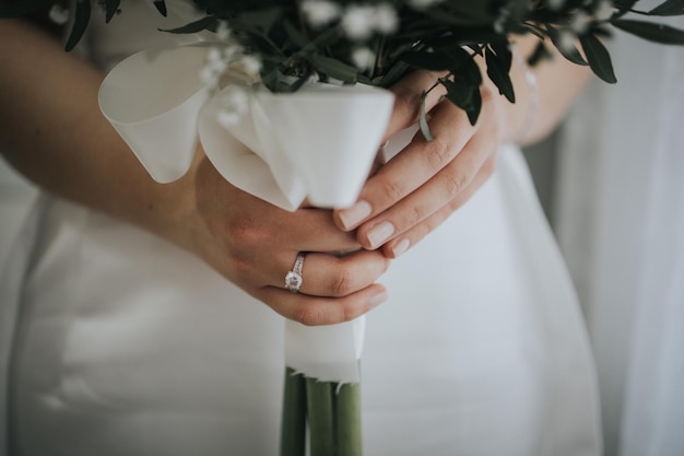 Bride wearing a wedding ring and holding her bouquet of flowers