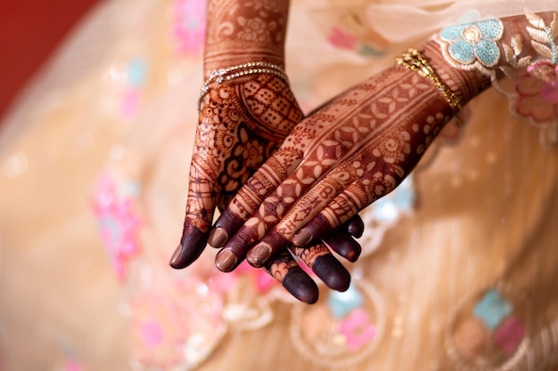 A bride wears henna on her hands.