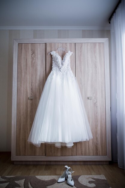 Bride wedding dress on the closet in the room