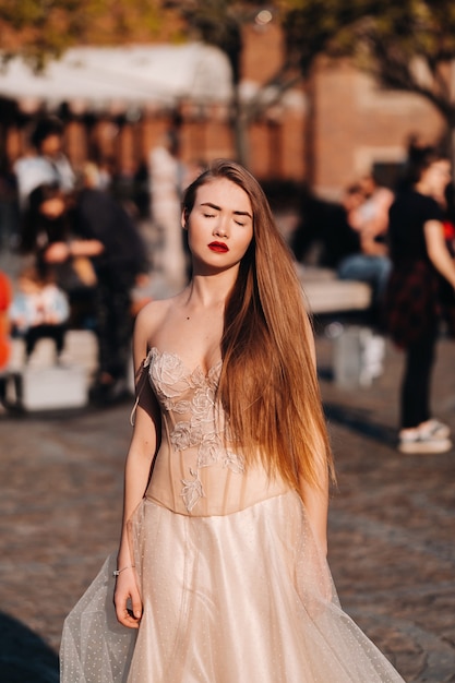 A bride in a wedding dress with long hair in the old town of Wroclaw. Wedding photo shoot in the center of an ancient city in Poland.Wroclaw, Poland.