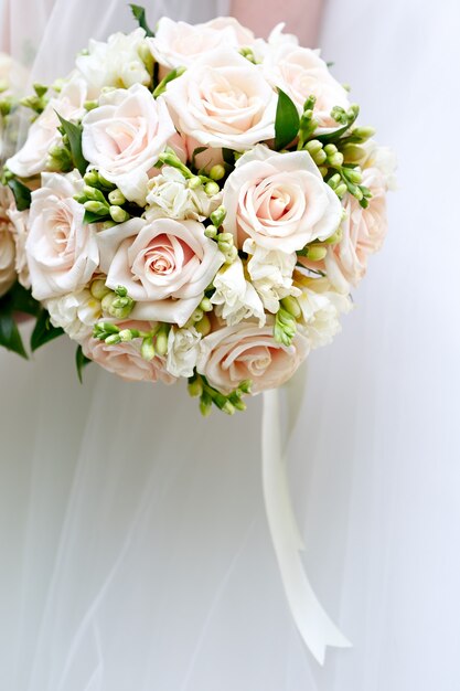 The bride at a wedding holding a bouquet of flowers.